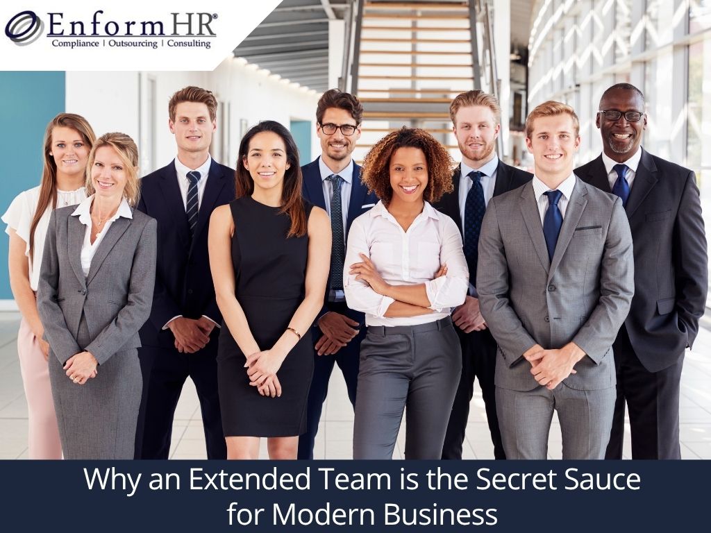 A professional group of diverse individuals standing together in a modern office space, symbolizing the concept of an extended team. The image emphasizes collaboration and teamwork in modern business.
